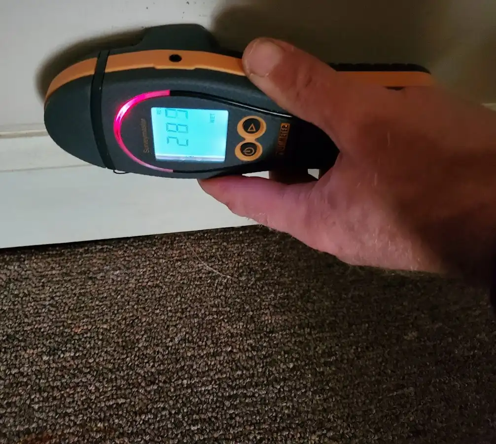 Moisture detection at baseboard during Storm Damage Restoration in Windham
